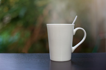 Hot coffee in a white cup on the table