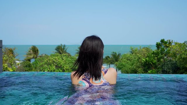 young japanese teen girl brunette tourist adult woman asian mature backpack looking the sky outdoors on paradise tropical beach viewpoint at PP Island, Krabi, Phuket, Thailand.