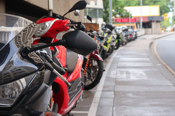 A row of motrobikes parking on a street