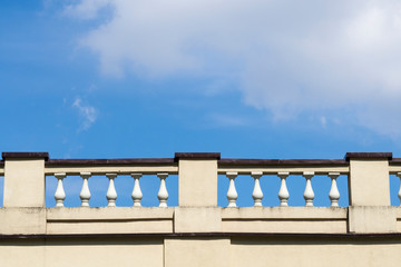 Architectural fence in the form of balusters against the blue sky