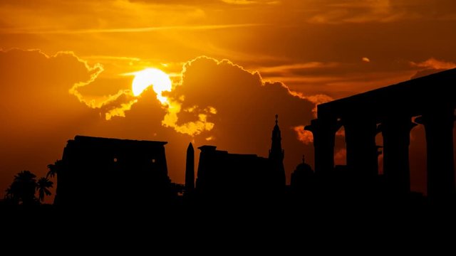 Luxor at Sunset: Ruins of Ancient Egyptian Temple Complex with Obelisk and Colonnades in Silhouette, Egypt, Africa