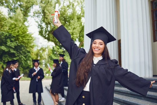 Young Hispanic Female Graduate Background Of Graduates At The University