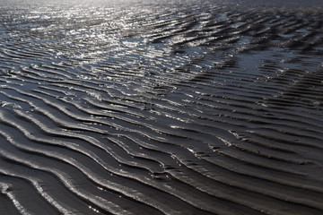 Wet wavy sand on beach in northern Germany