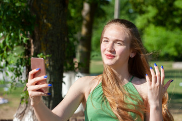 Spring girl. Lovely blond girl with bunch of dandelions outdoors.