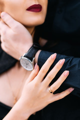man embraces a woman. couple in love in black. gold ring on the