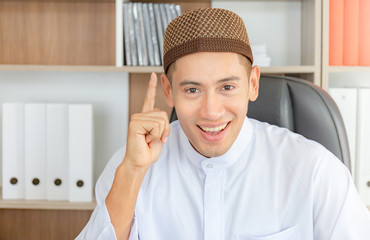 Selective focus of Happy young business arab middle eastern muslim man in office