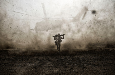 Military soldier and helicopter between storm & dust