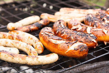 the process of cooking sausages or sausages on the grill