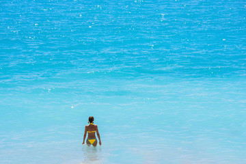 Woman with healthy body on the beach - beach vacation