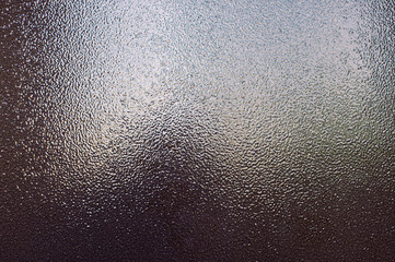 Background of brown bronze textured metal that glitters in the light