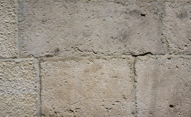 The wall made of grey bricks 