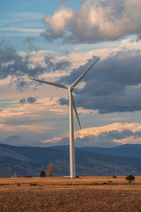 Wind turbine against a background of cloudy sky