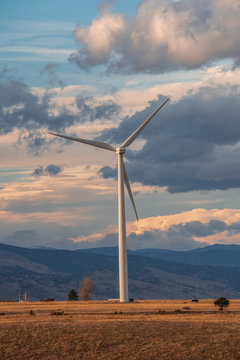 Wind turbine against a background of cloudy sky