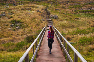 Young girl on a bridge with stairs behind her