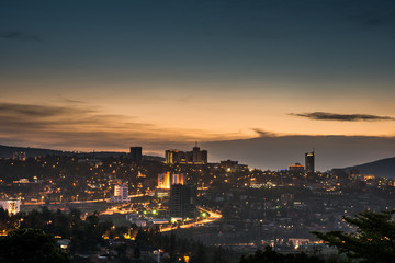 Fototapeta na wymiar Kigali city centre skyline and surrounding areas lit up at dusk. Rwanda
