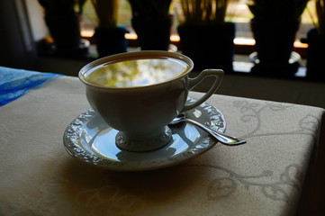 reflection of the cloudy sky on the surface of coffee