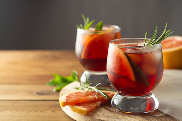 Summer drink. Fruit refreshing cold cocktail. Wooden table.