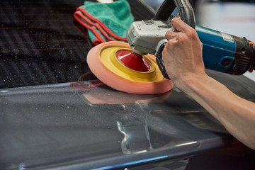 Hands Polishing Car With Rotary Car Polisher