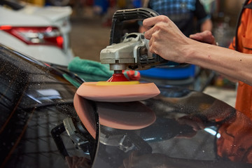 Hands Polishing Car With Rotary Car Polisher