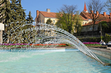 fountains with flower beds in the city and parks of a beautiful sunny day under the blue sky