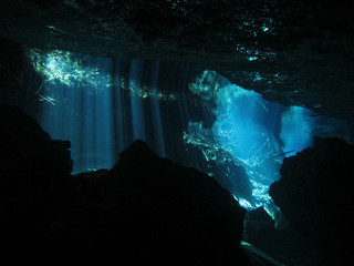 Sun rays entering the water - Underwater at cenote Chac Mool in the Riviera Maya, Mexico.