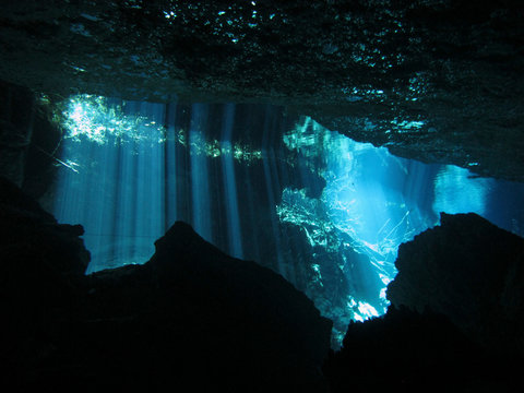 Sun rays entering the water - Underwater at cenote Chac Mool in the Riviera Maya, Mexico.