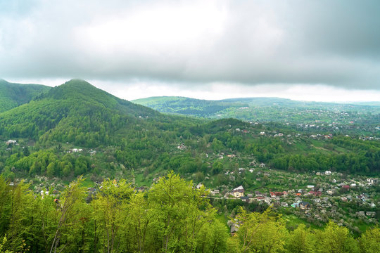 Panoramic view of village in spring mountain forest. Kosiv, Ukraine