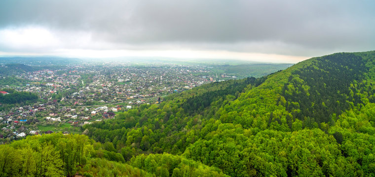 Panoramic view of village in spring mountain forest. Kosiv, Ukraine