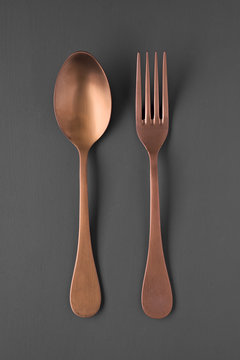 Overhead Shot Of Copper Fork And Spoon Isolated On Gray Background