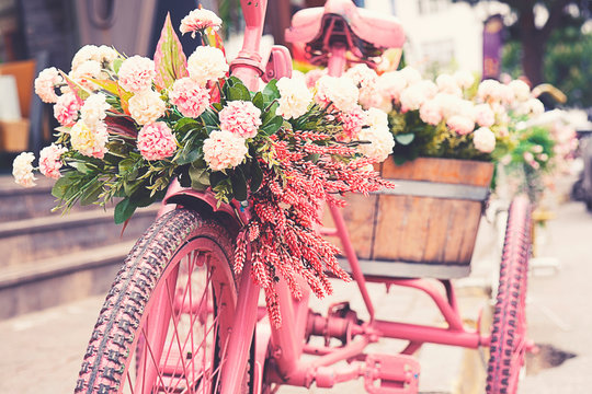 Rusty tricycle bike with flower pot in tray against blured background. - Powered by Adobe