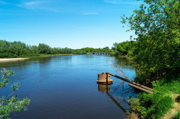 Fototapeta na wymiar River in rural terrain at spring length of time
