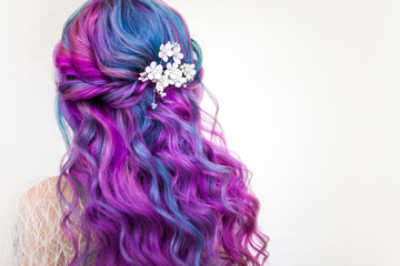 Beautiful and healthy hair with bright coloring. Long curly hair purple and pink tones