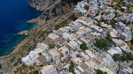 Aerial drone photo of picturesque main village (chora) of Folegandros island featuring uphill church of Panagia (Virgin Mary) built on top of steep hill overlooking the Aegean sea, Cyclades, Greece