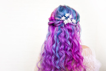 Stylish trendy hairstyle of curly blonde hair. Fashionable hair coloring,