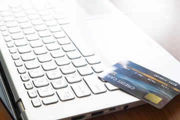 Close up credit card on laptop computer. Selective focus on keyboard. Technology, e-payment and gadget concept