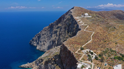 Naklejka premium Aerial drone photo of iconic and picturesque main village (chora) of Folegandros island featuring castle and built on top of steep hill overlooking the Aegean blue sea, Cyclades, Greece