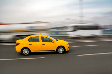 Fototapeta na wymiar Evening traffic long exposure yellow turkish taxi car on istanbul 