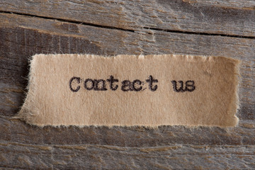 Contact Us word on a piece of paper close up, business creative motivation concept