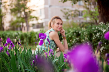 woman in spring. Portrait of a girl in a blooming garden.  woman is walking in the summer in the park. Happy middle-aged woman