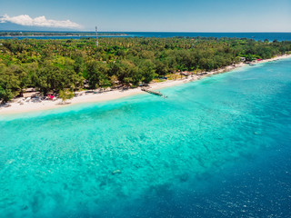 Tropical island with beach and turquoise ocean. Aerial view.
