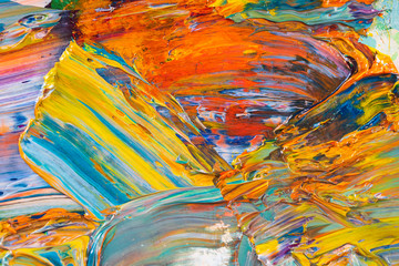 Bright, juicy, multi-colored abstraction of their mixing of oil paints on a palette close-up.