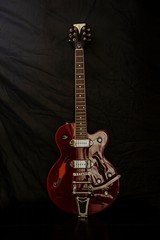 Fototapeta na wymiar Semi acoustic electric guitar in red color.
