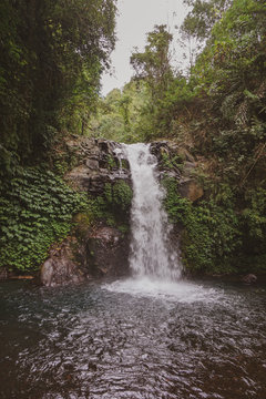 The waterfall is a popular tourist destination in Bali, known for its surrounding attractive foliage