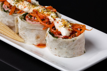 Rolls with pita and ham on white plate