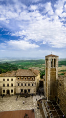 View of Piazza Grande and the bell tower of the Duomo of Montepulciano and the Chianti countryside.