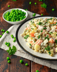 Russian traditional salad Olivier with vegetables and meat.