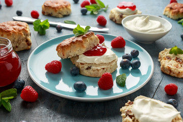 Classic English scones with clotted cream, strawberries jam and other fruit