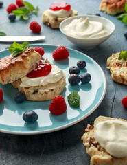Classic English scones with clotted cream, strawberries jam and other fruit