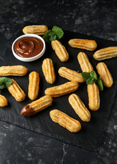 Churros with chocolate dipping sauce. sugar and cinnamon.