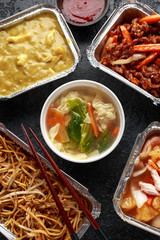 Chinese takeaway food. Pork Wonton dumpling soup, Crispy shredded beef, sweet and sour pineapple chicken, egg noodles with bean sprouts, curry.